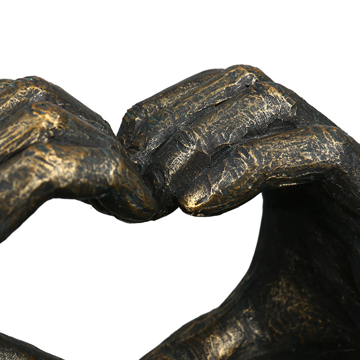 Gilde bronze sculpture featuring a heart-shaped hand motif, showcasing detailed poly bronze craftsmanship.