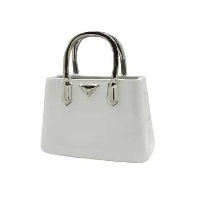 White ceramic Gilde Milan Vase styled as a handbag, 26cm tall, with intricate design details visible.