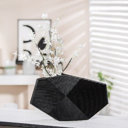 Black Gilde Heptagon Vase Made of resin, 22cm tall, with a modern geometric design and sleek matte finish.