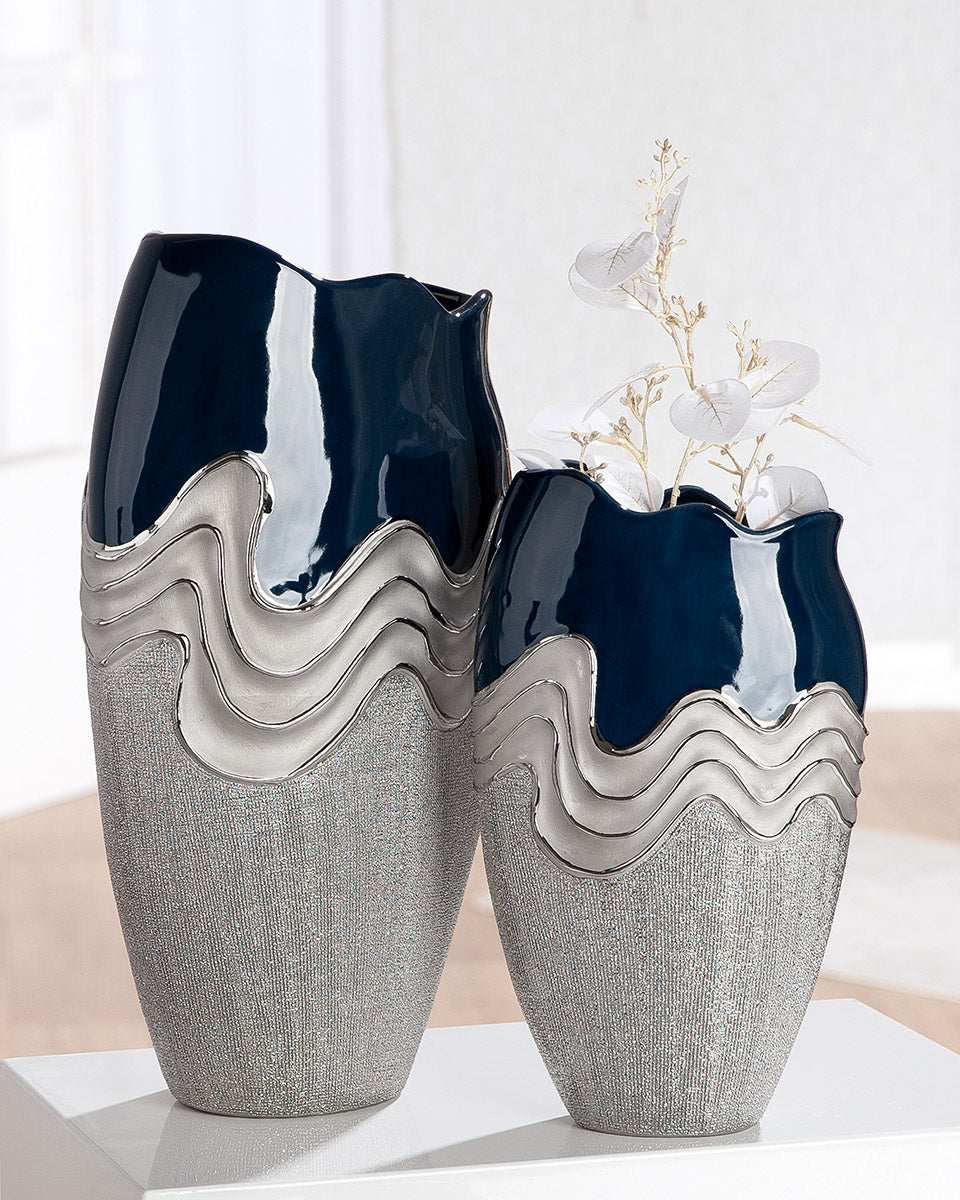 Dark blue ceramic Gilde conical vase with wavy design and silver accents, showcasing its elegant, artistic shape.