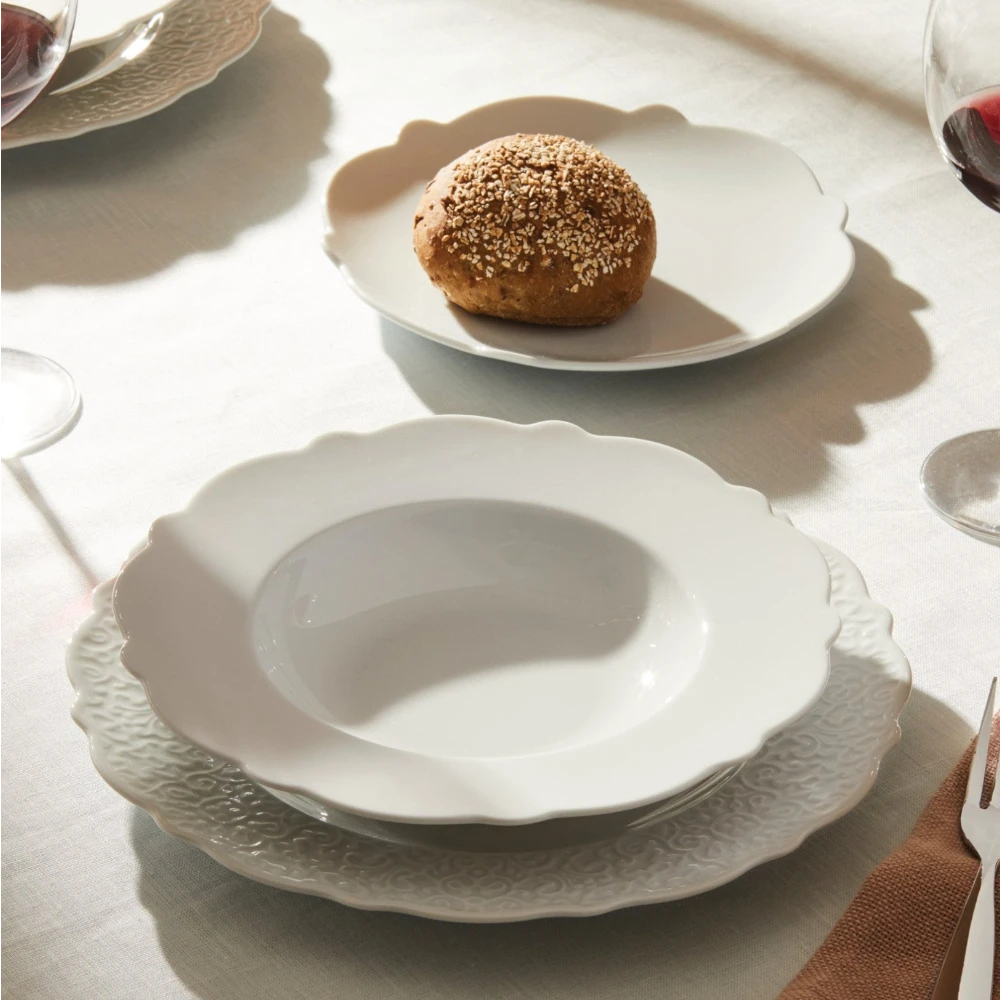 Alessi dressed porcelain soup bowl with elegant design, featuring a smooth white finish and decorative accents.