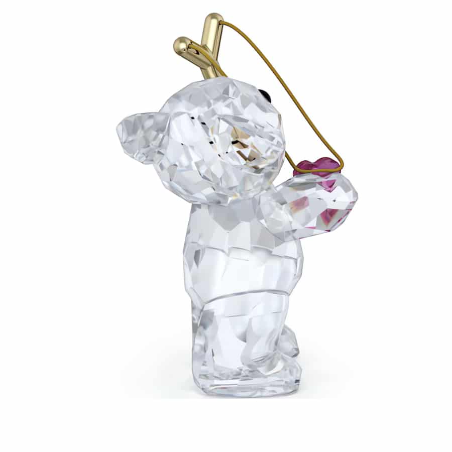 Swarovski Kris Bear Sending You Love figurine with crystal details, featuring a cute bear holding a heart-shaped object.
