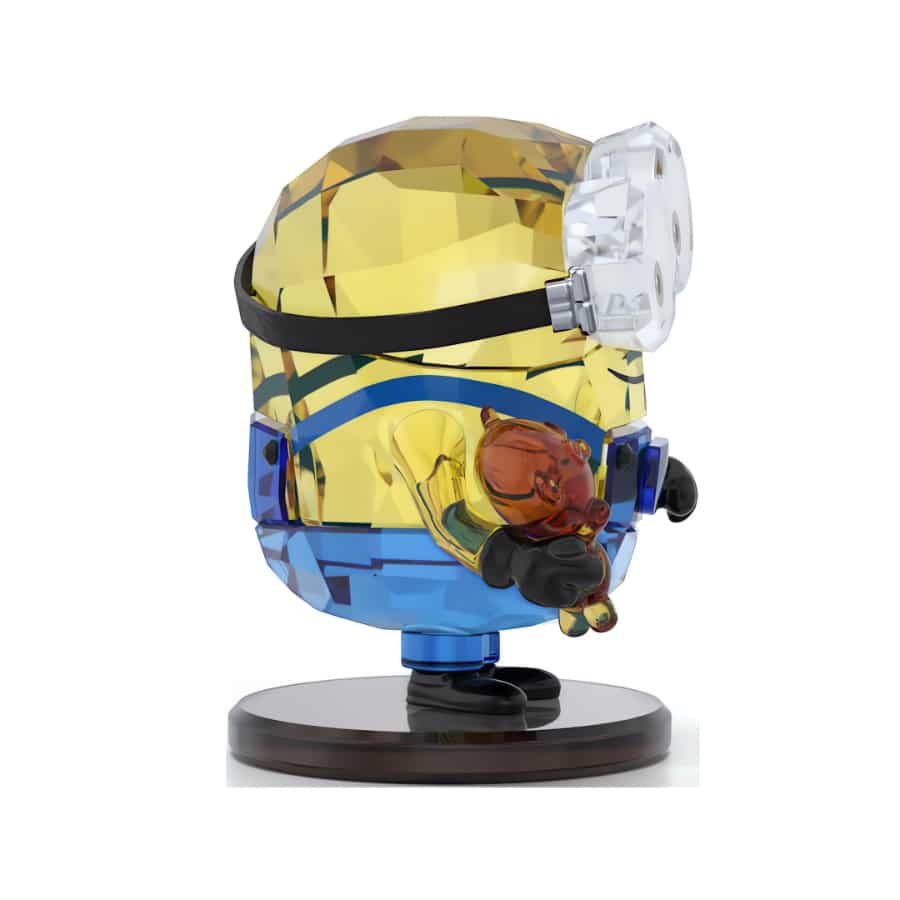 Swarovski Minions Bob figurine with crystal detailing, featuring Minions character in playful pose with bright yellow and blue colors.