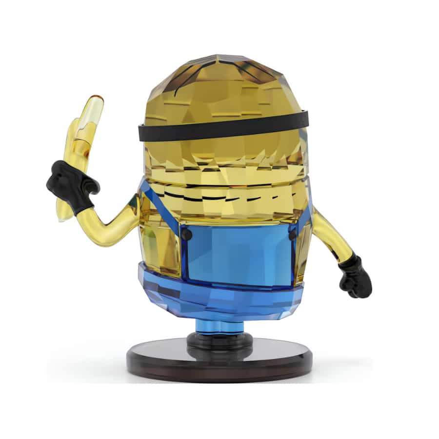 Swarovski Minions Stuart crystal figurine with detailed yellow body and blue overalls, featuring sparkling crystal accents.