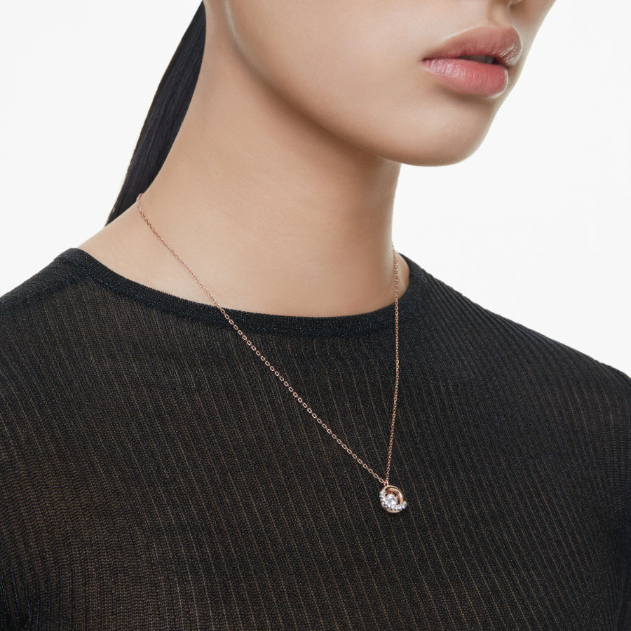 Swarovski Dextera pendant with round white crystal, rose gold-tone plated jewelry, showcasing elegant design and sparkling details.
