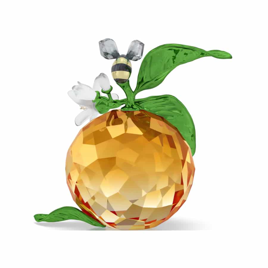 Swarovski Idyllia Clementine and Bee figurine featuring a crystal bee perched on an orange-colored Clementine.