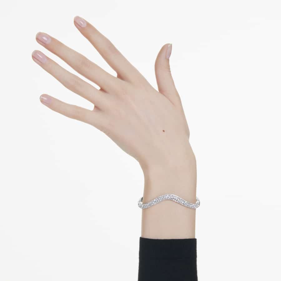 Swarovski Sublima bangle with round-cut white crystals and rhodium plating, showcasing elegant jewelry design.