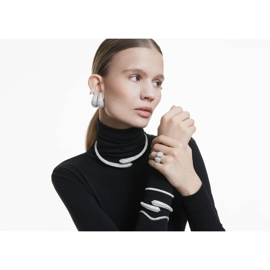 Swarovski Sublima bangle with round cut white crystals, rhodium plated, sleek and elegant jewelry accessory.