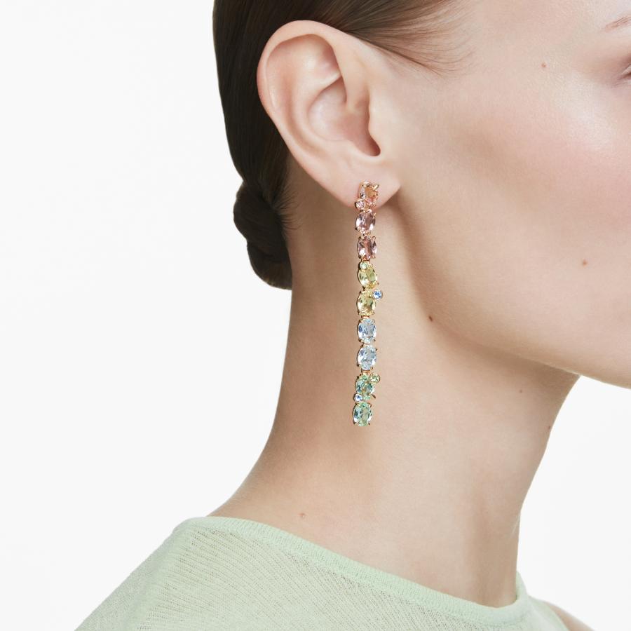 Swarovski Gema Drop earrings with asymmetrical design, multicolored crystals, and gold-tone plating, showcasing mixed cuts and sparkle.