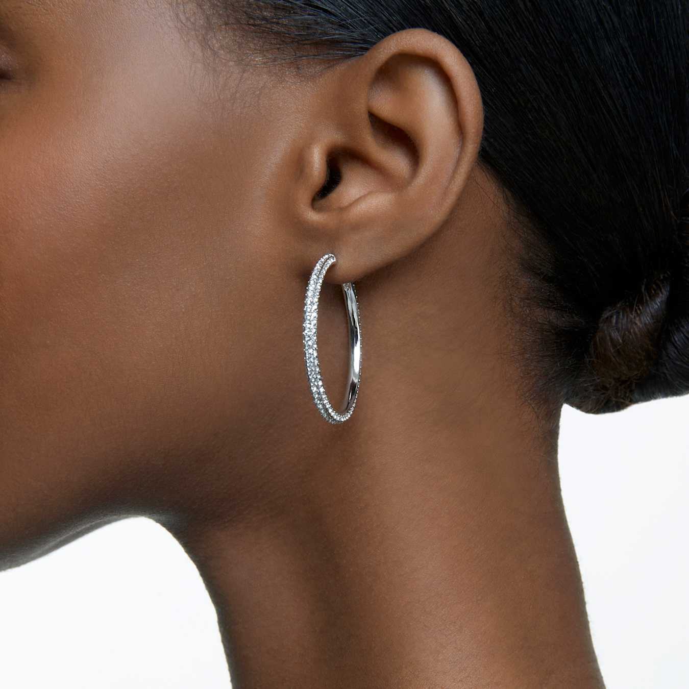 Large Swarovski Dextera hoop earrings with pavé white crystals and rhodium plating, showcasing elegant jewelry design.