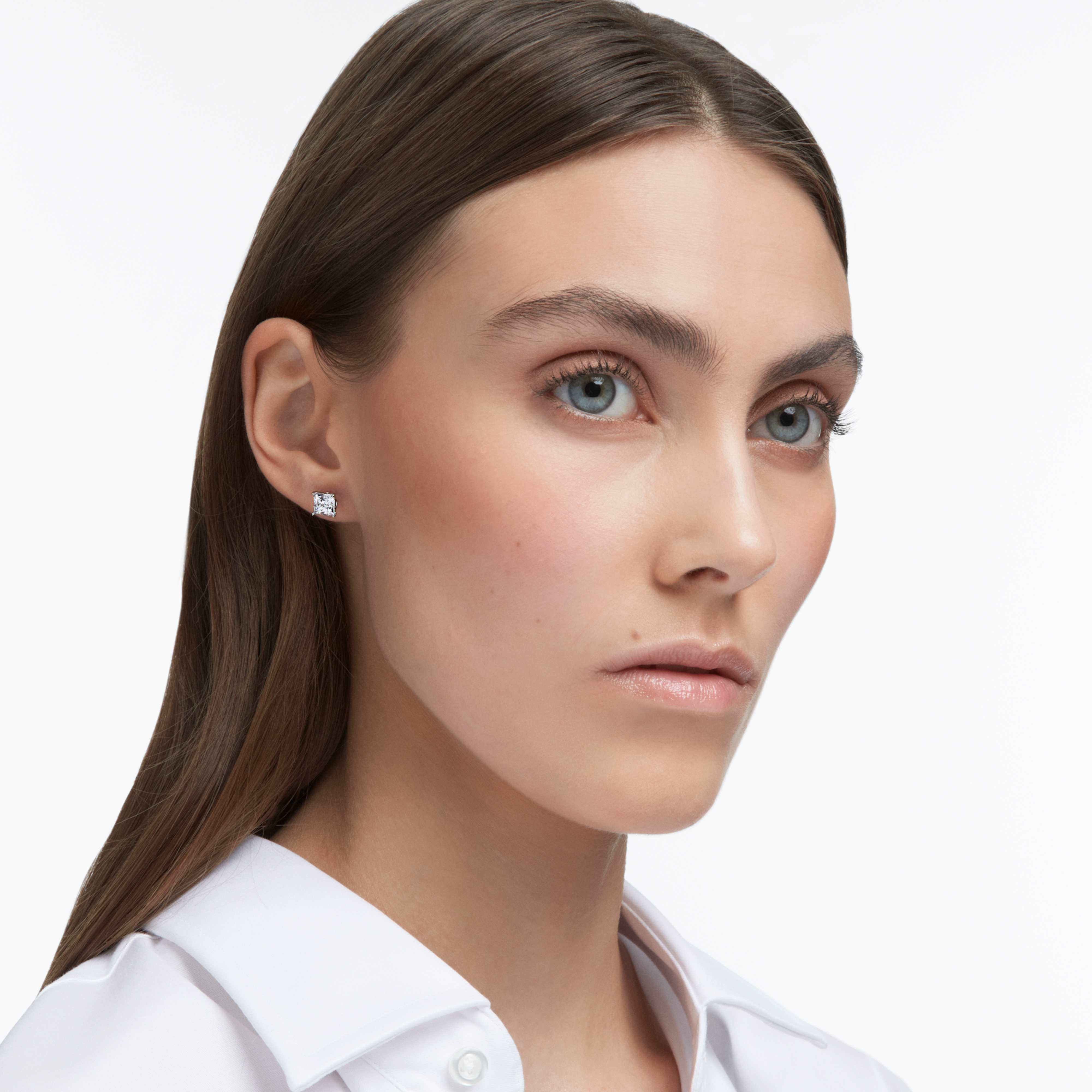 Swarovski Stilla Attract square cut white stud earrings with rhodium plating, showcasing elegant jewelry design.