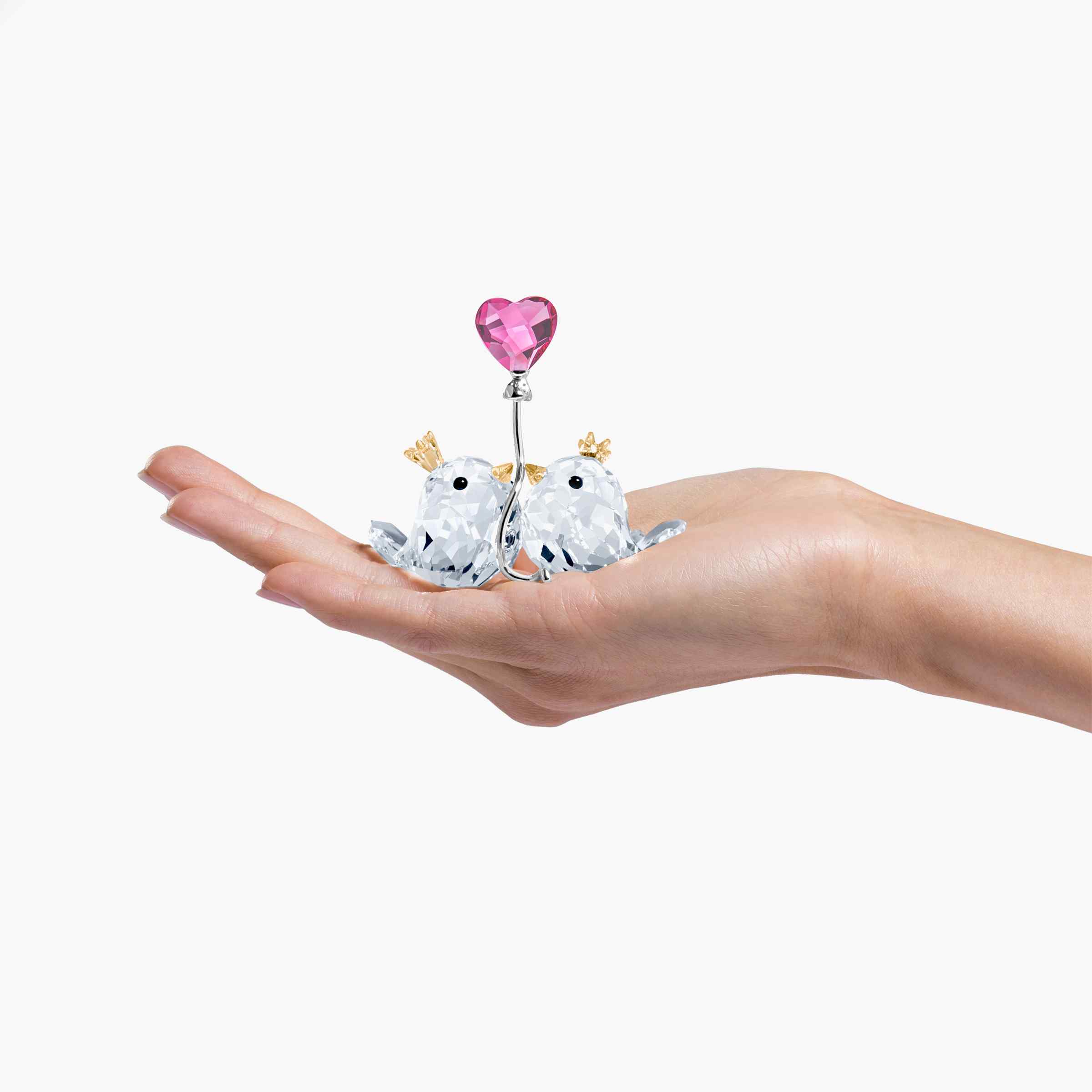 Swarovski Love Birds figurine with pink heart, sparkling crystal craftsmanship, decorative ornament for display or gift.