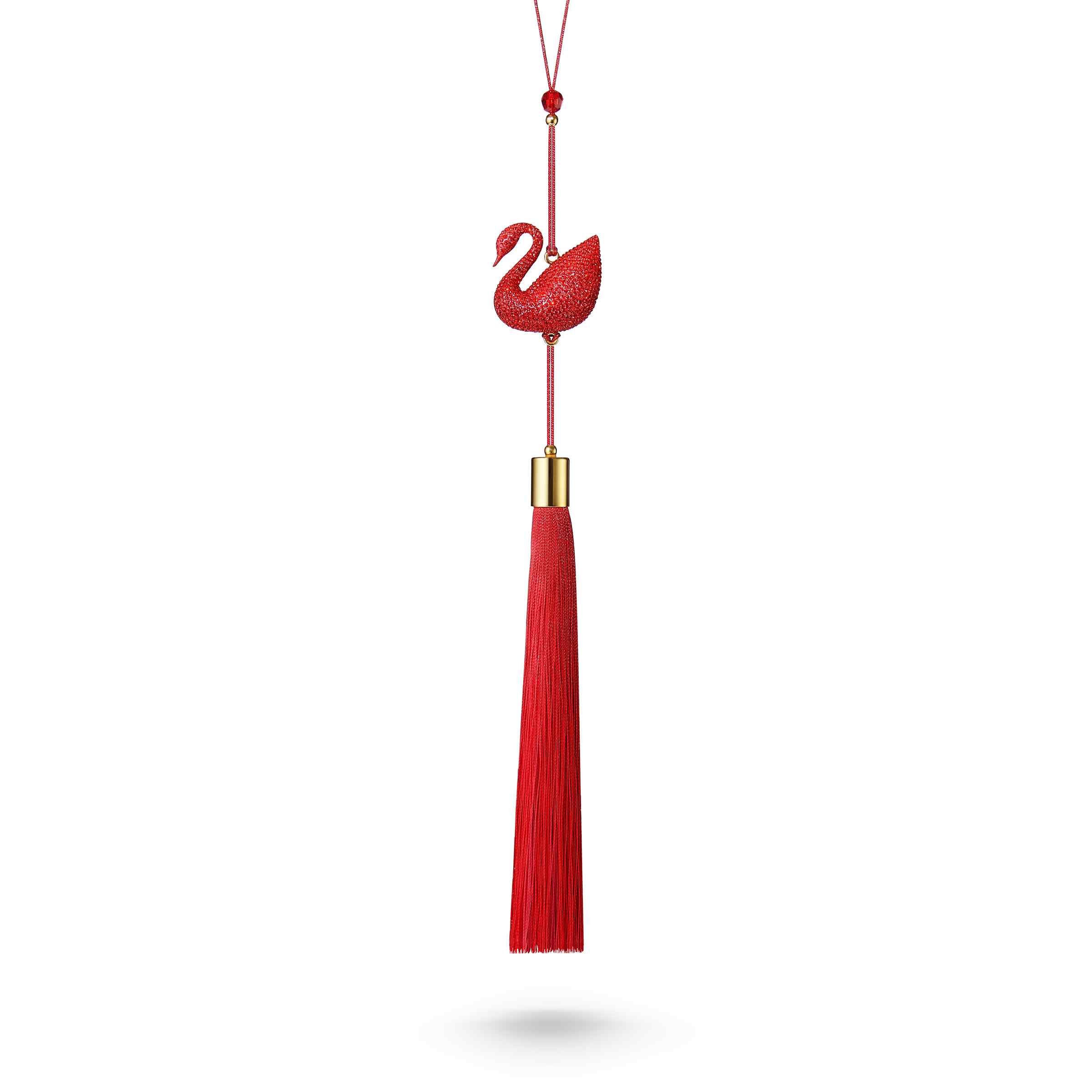 Swarovski red swan figurine with crystal details, showcasing elegance and craftsmanship on a clear display surface.
