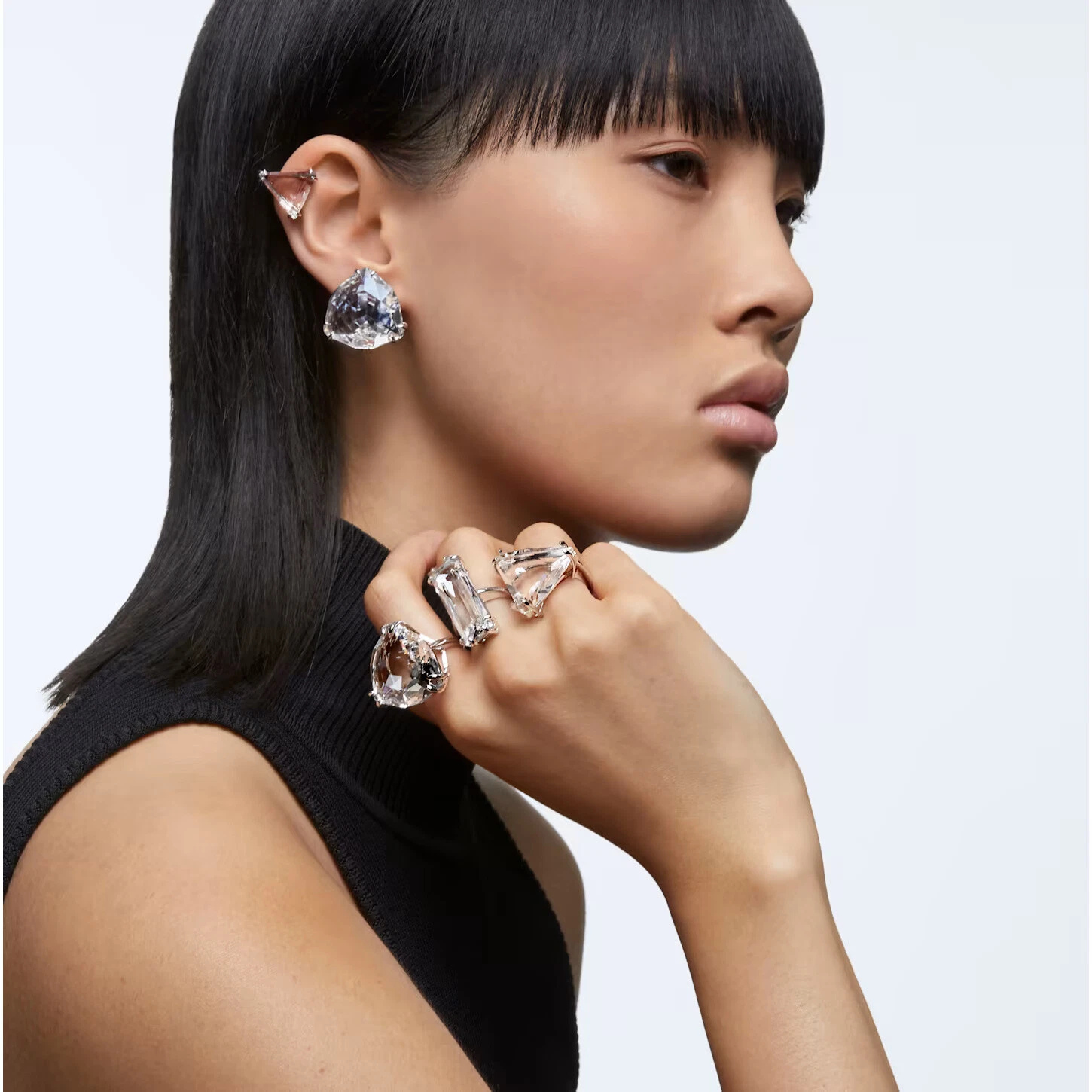 Swarovski Mesmera clip earring with single triangle-cut crystal, white rhodium plating, elegant jewelry accessory.