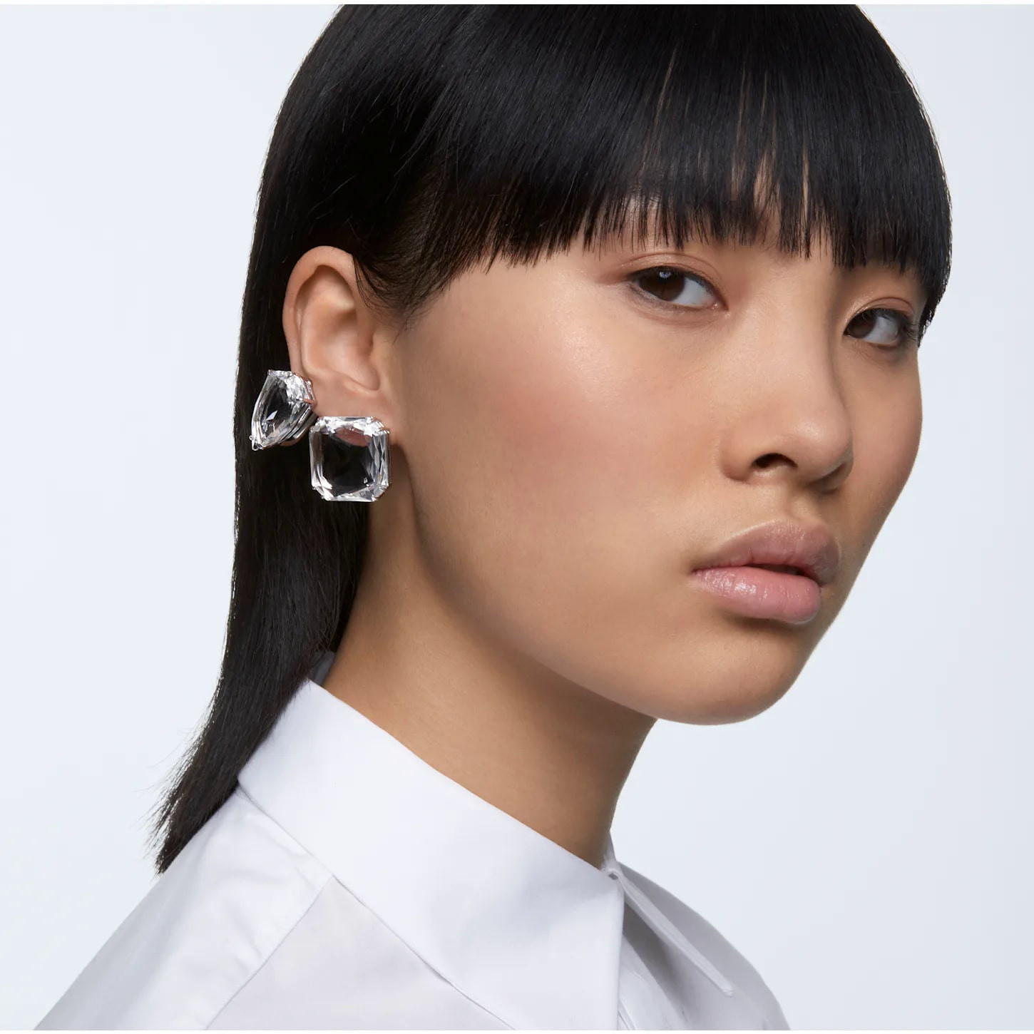 Swarovski Mesmera clip earring with a single square cut white crystal, set in white rhodium plating, elegant jewelry accessory