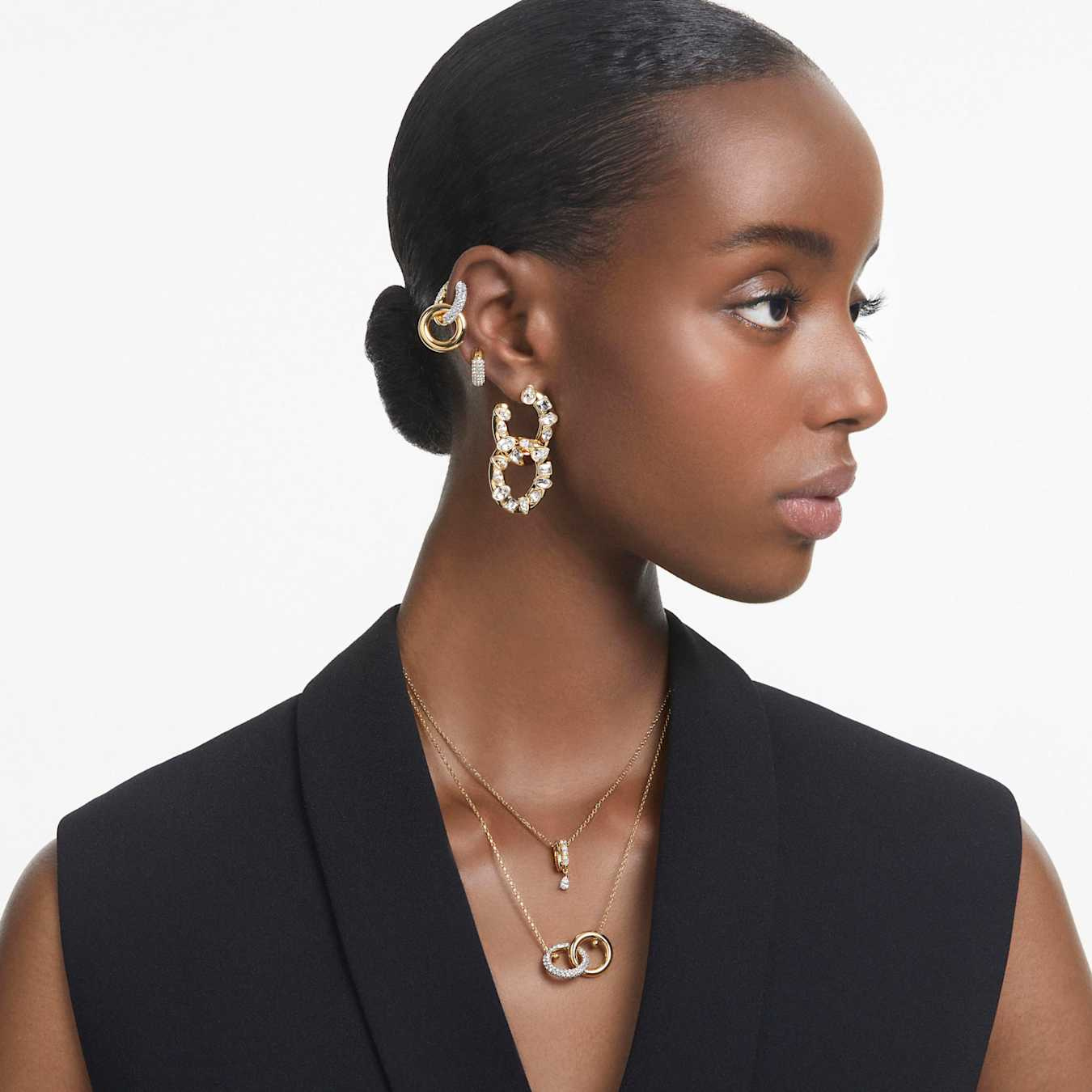 Swarovski Dextera small hoop earrings in white with gold-tone plating, showcasing elegant and stylish jewelry design.