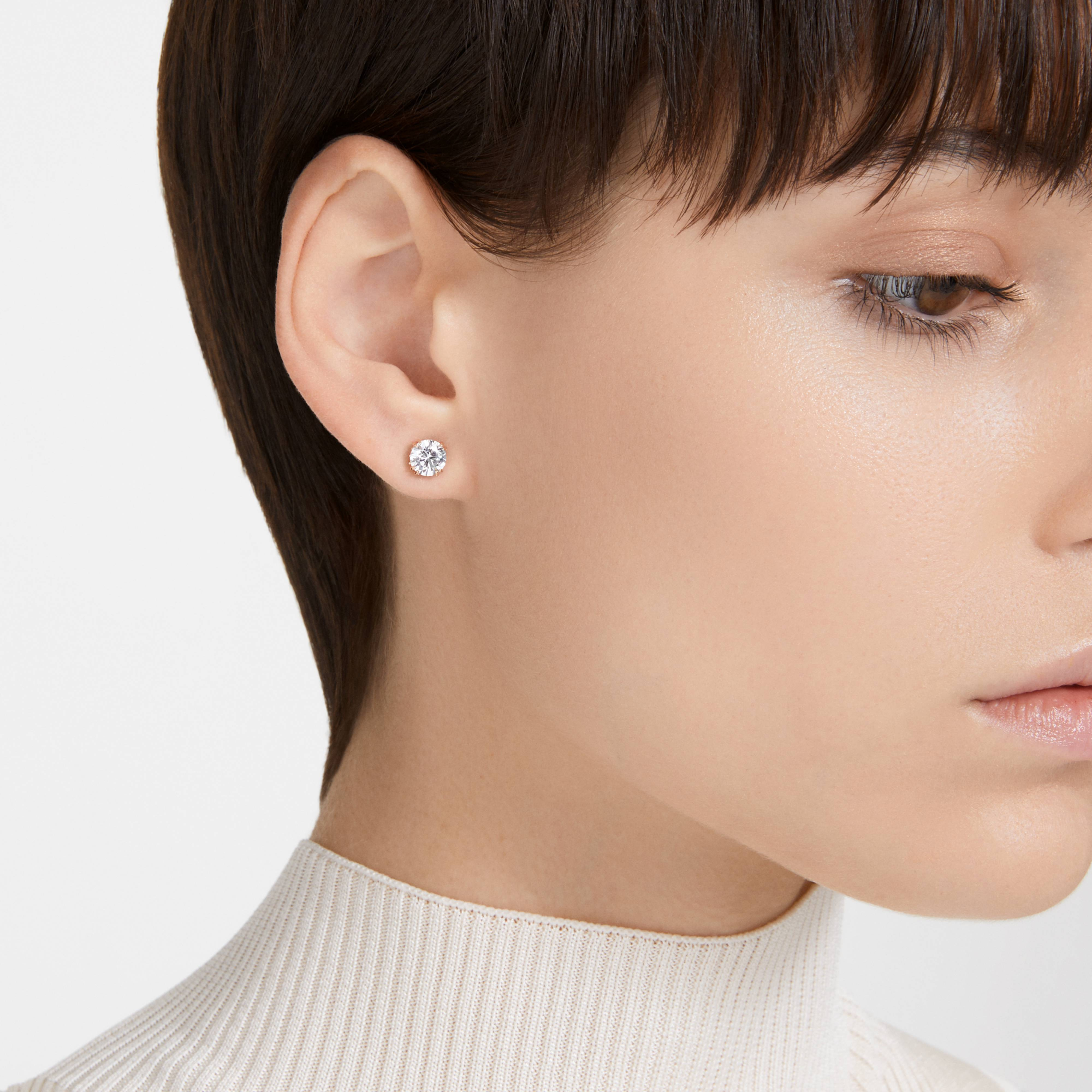 Swarovski Constella stud earrings with round cut crystals, showcasing elegant silver-tone settings and sparkling gemstone details.
