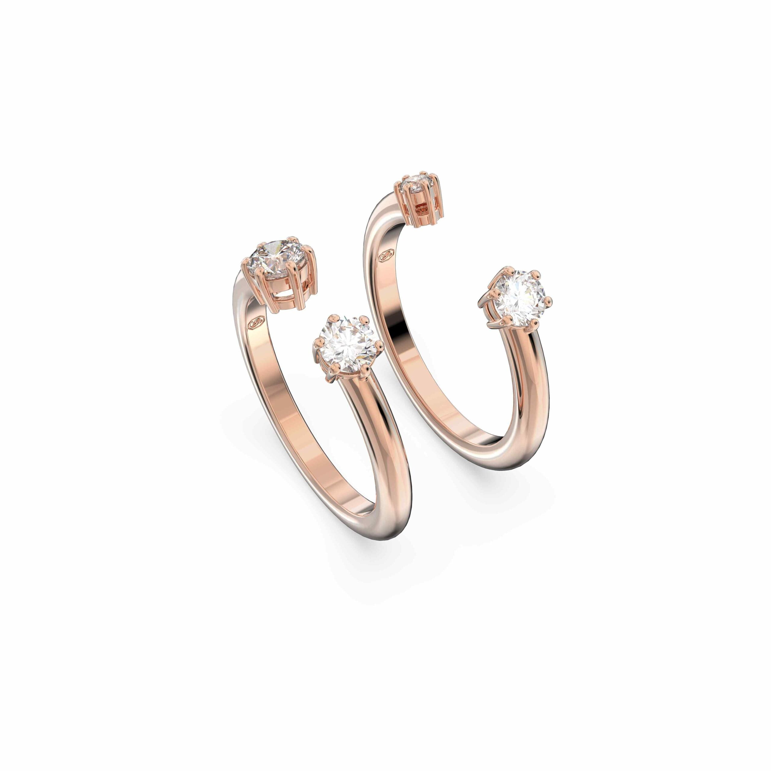 Two Swarovski Constella rings in rose-gold plating with round-cut white stones, showcasing elegant jewelry design.