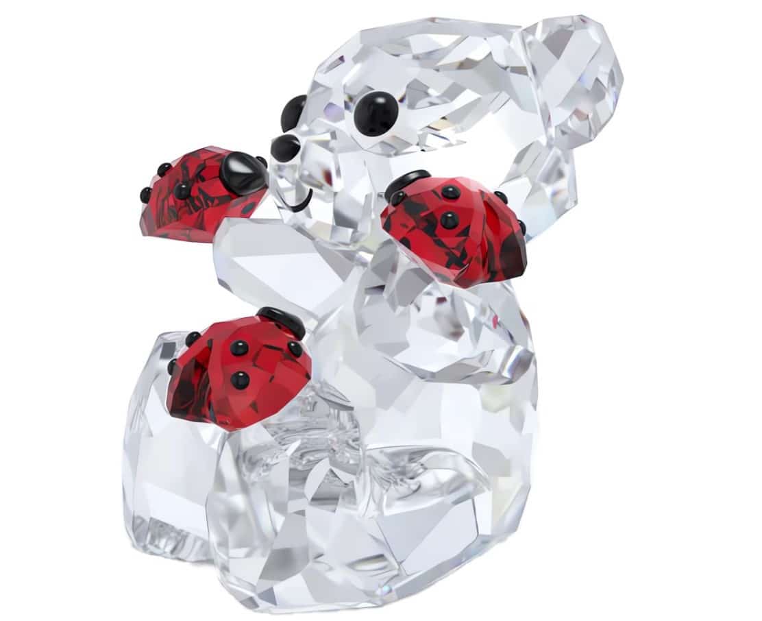 Swarovski Kris Bear Good Luck Bear figurine with clear crystal details, featuring a cute bear holding a four-leaf clover.