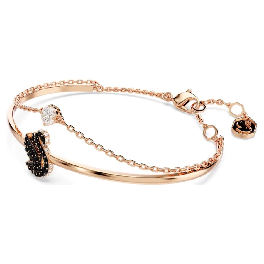Swarovski black swan figurine with rose gold-tone plated accents, detailed crystal craftsmanship, elegant decorative piece.