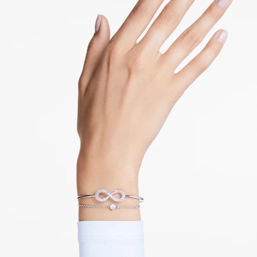 Swarovski Hyperbola Bangle Infinity in white rhodium plating, showcasing sleek, modern jewelry design with sparkling accents.