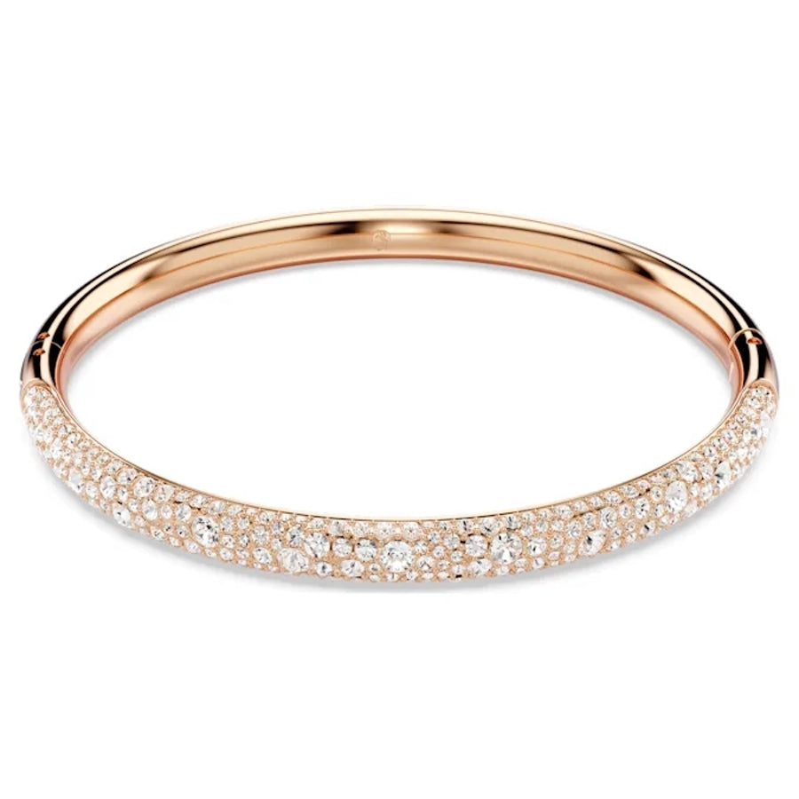 Swarovski Meteora Bangle with snow pavé white crystals on rose gold-tone plated metal, elegant jewelry accessory.