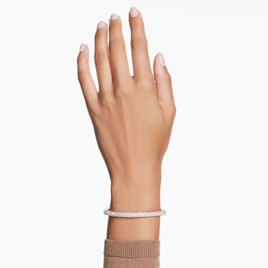 Swarovski Meteora Bangle with snow pavé white crystals in rose gold-tone plated finish, stylish jewelry accessory.