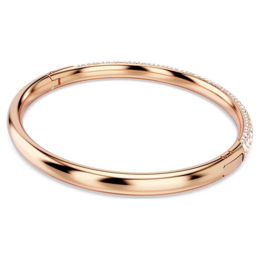 Swarovski Meteora Bangle with snow pavé white crystals on rose gold-tone plated metal, elegant jewelry accessory.