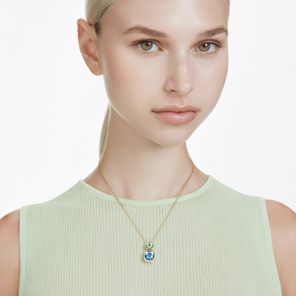 Swarovski Chroma pendant with multicolored cushion cut crystal, gold-tone plated jewelry piece on a white background.