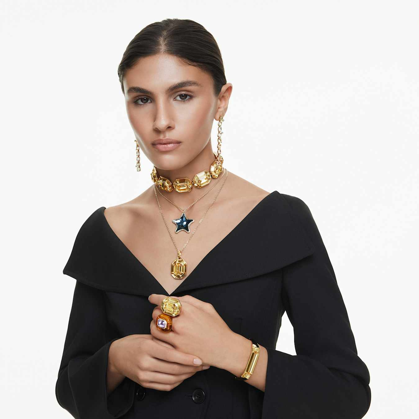 Swarovski Gema Drop earrings with asymmetrical multicolored crystals and gold-tone plating, featuring mixed cuts and elegant design.