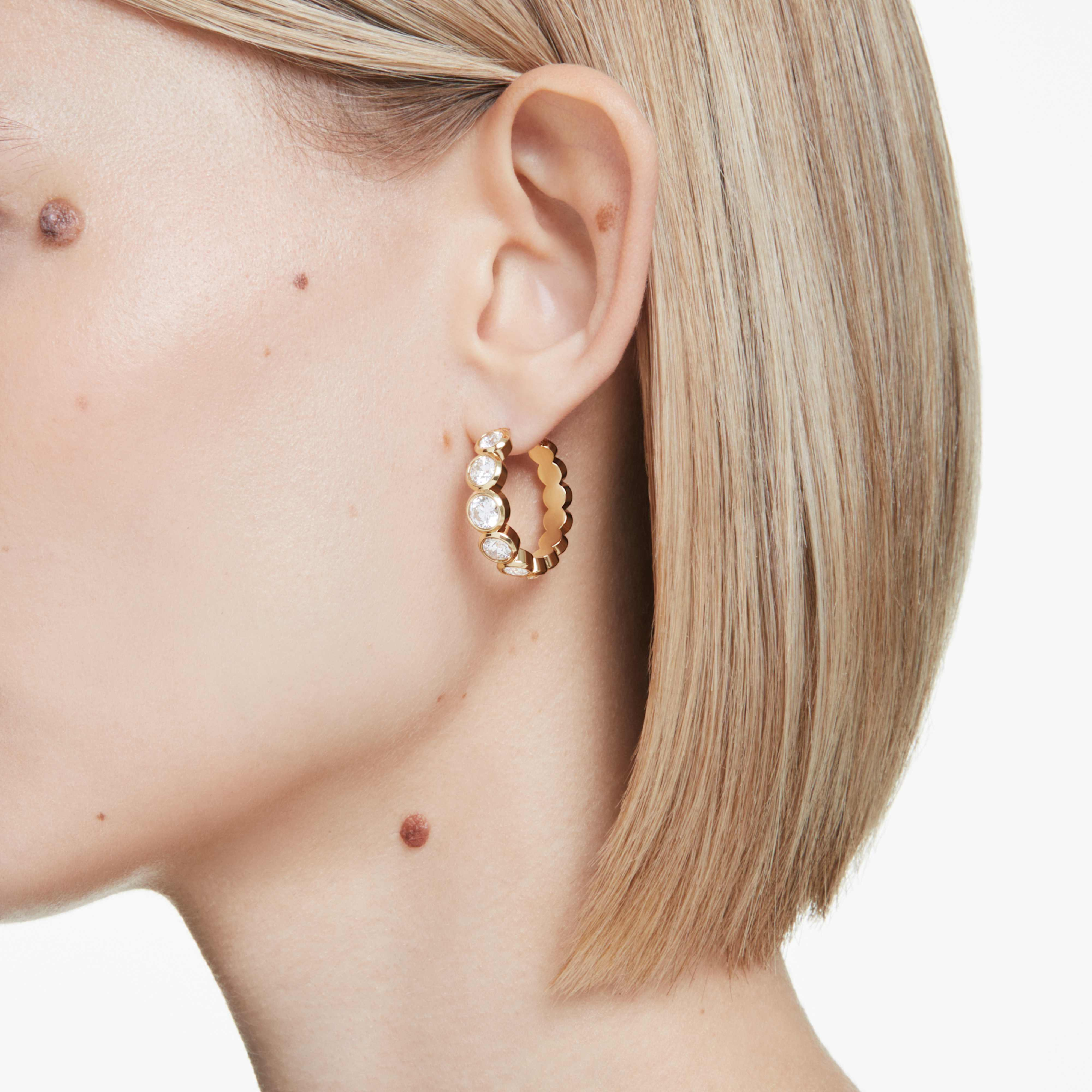 Swarovski Imber hoop earrings with round cut white crystals and gold-tone plating, showcasing elegant jewelry design.