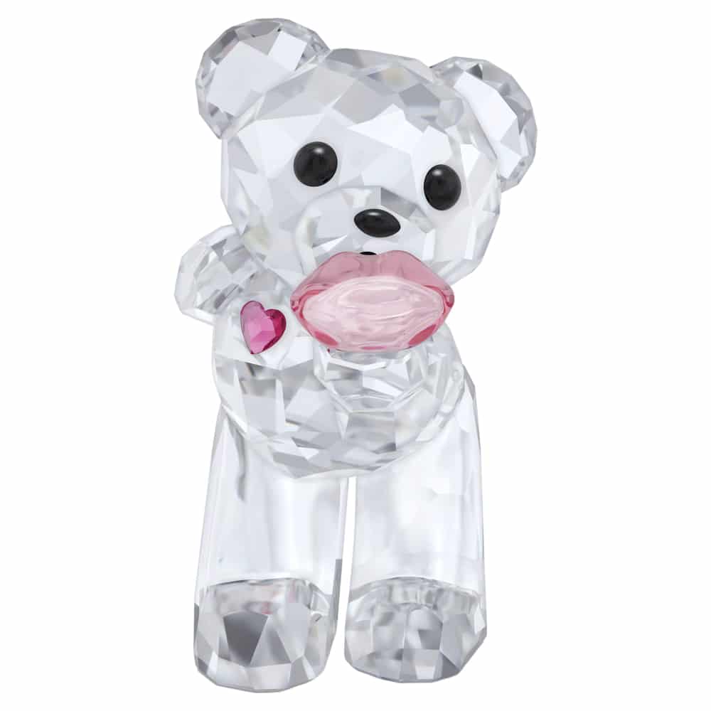 Swarovski Kris Bear A Kiss full of Love crystal figurine with a smiling bear holding a heart-shaped object, detailed and sparkling.