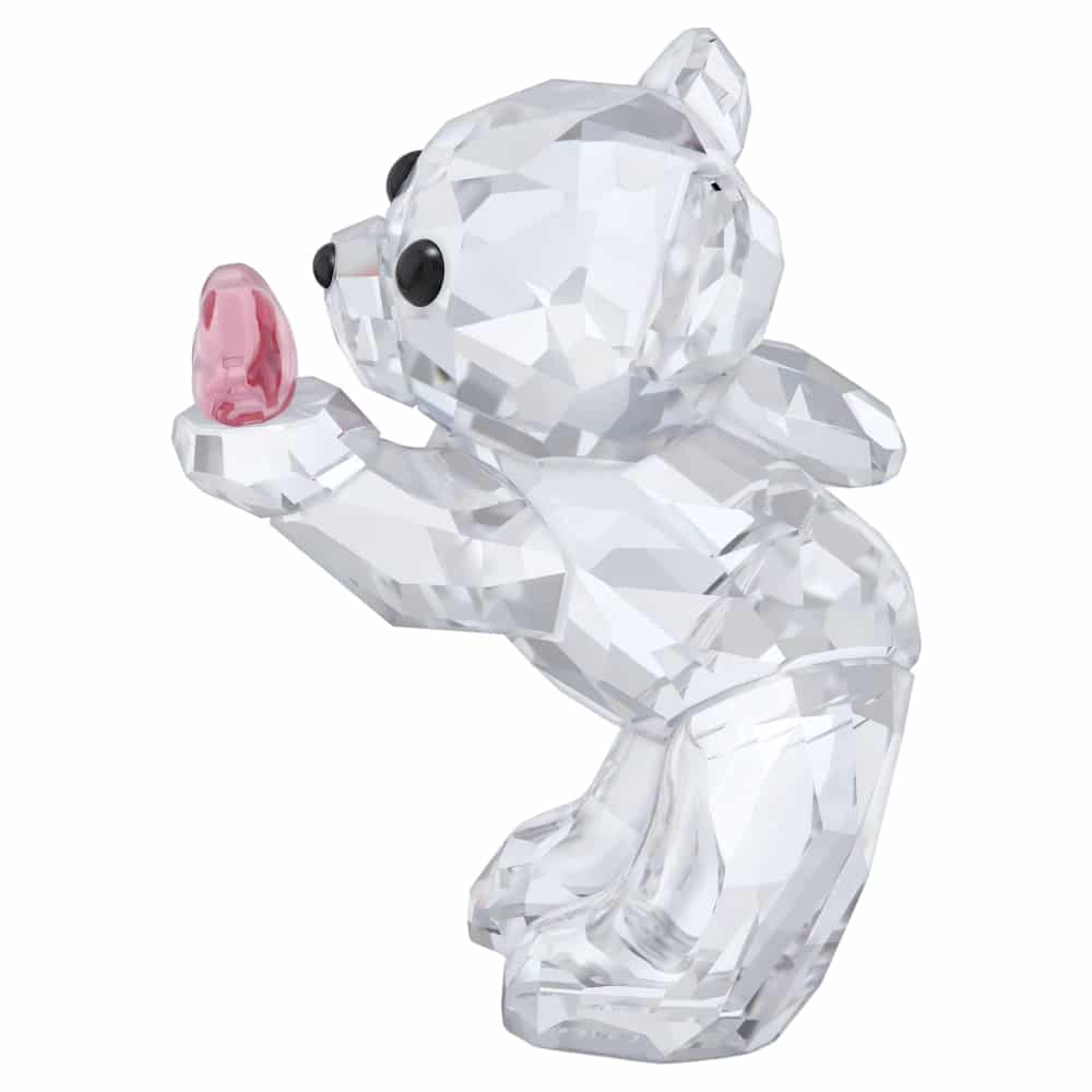 Swarovski Kris Bear A Kiss full of Love figurine with clear crystal detailing and a cute bear holding a heart-shaped object.