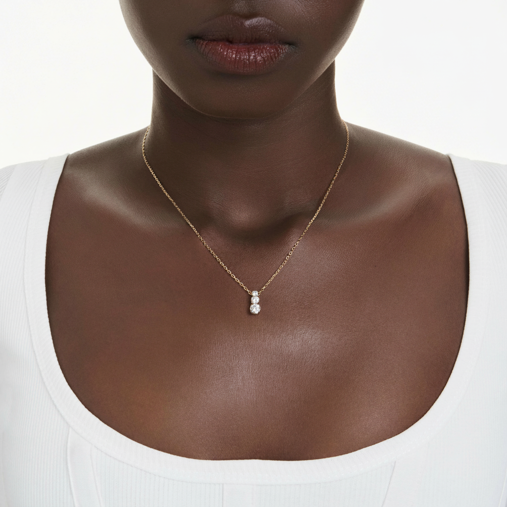 Swarovski Stilla Attract pendant with round white crystal, gold-tone plated jewelry, featuring sparkling gemstone design.