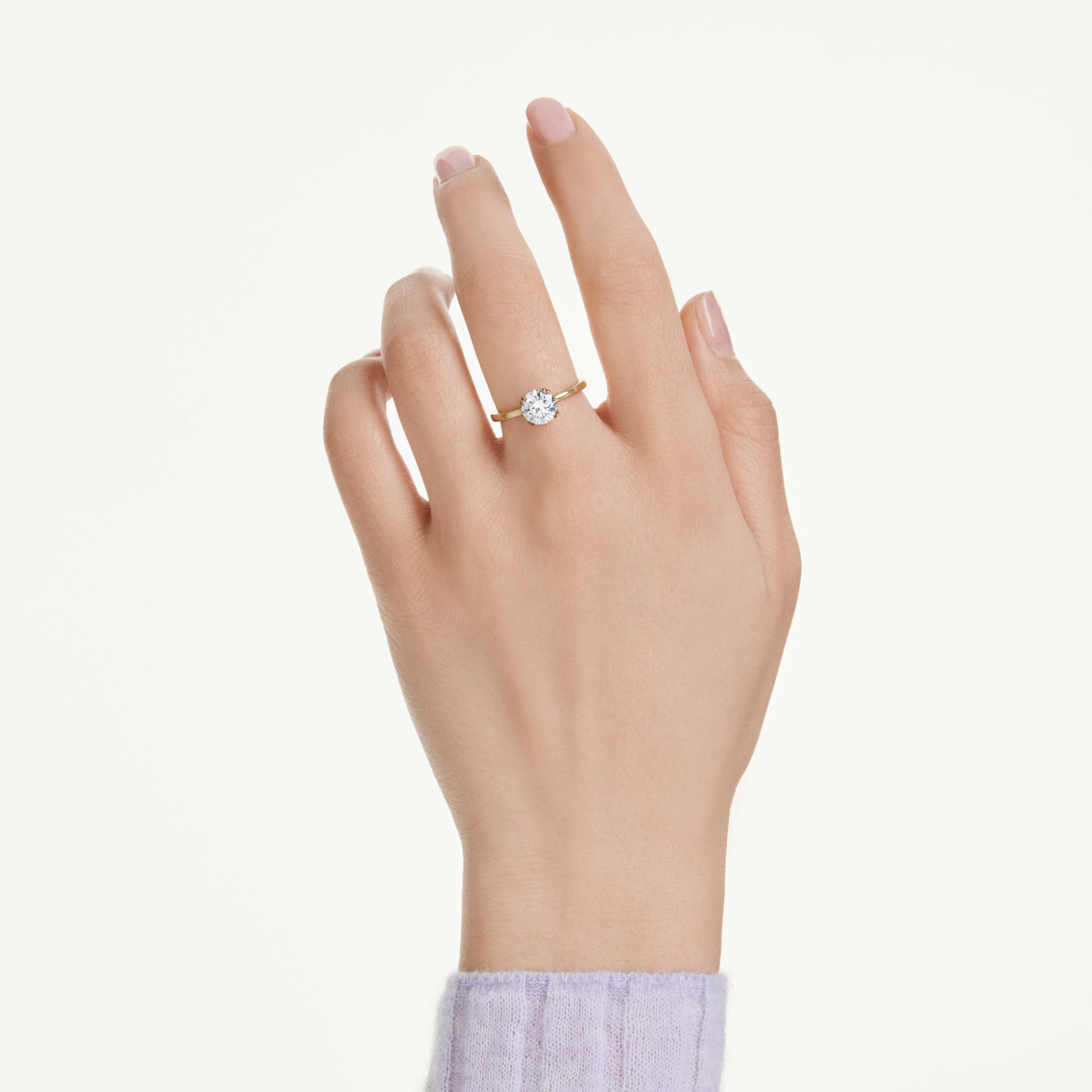 Swarovski Stilla Attract cocktail ring with round white crystal, gold-tone plated band, elegant jewelry accessory.