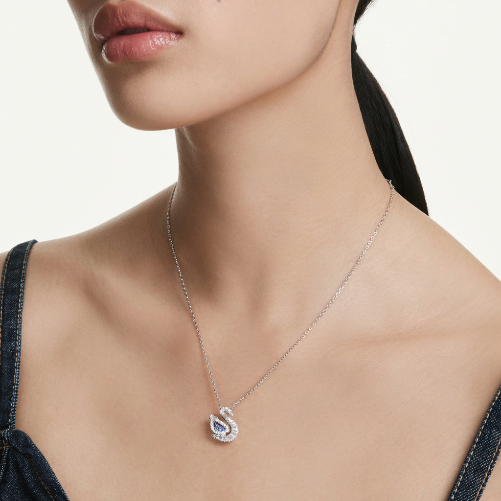 Swarovski Swan Pendant in blue with mixed cut crystals, featuring a graceful swan design and sparkling gemstone accents.