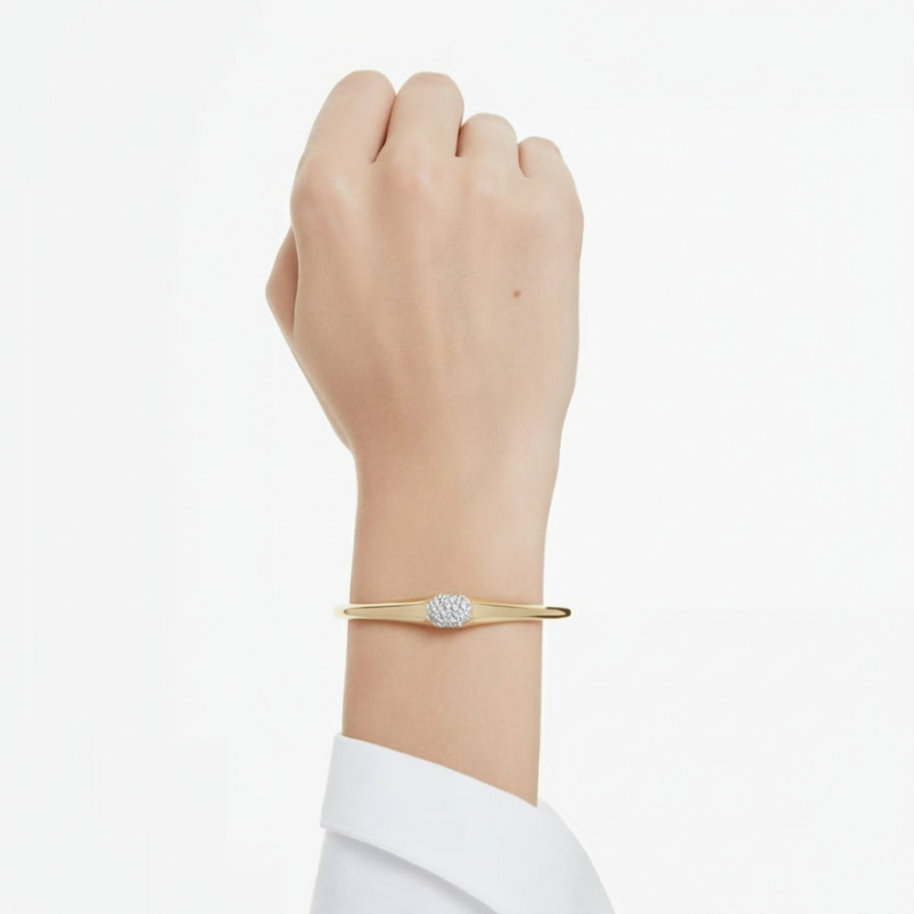 Swarovski Dextera gold-tone plated bangle with round-cut white crystals, elegant jewelry accessory.