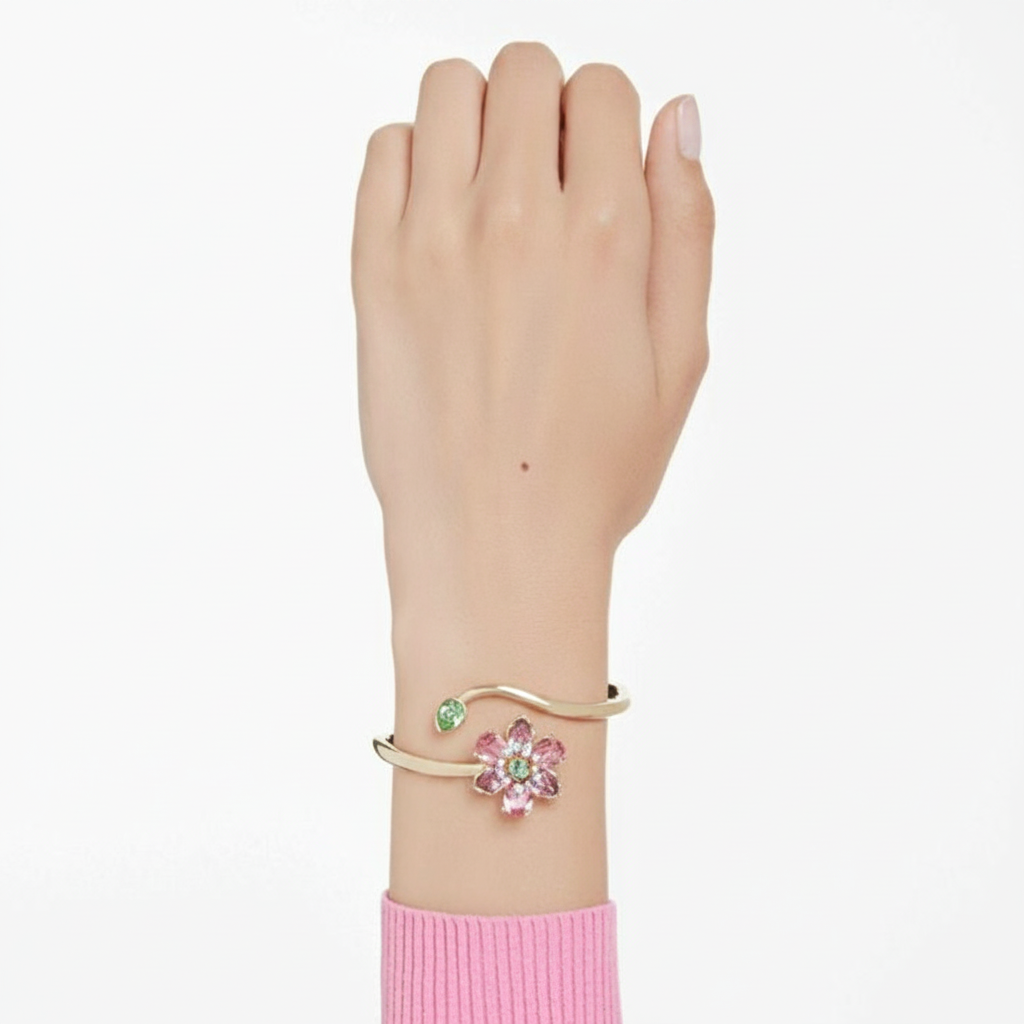 Swarovski Idyllia Bangle featuring sparkling crystal accents and a sleek silver-tone design on a white background.