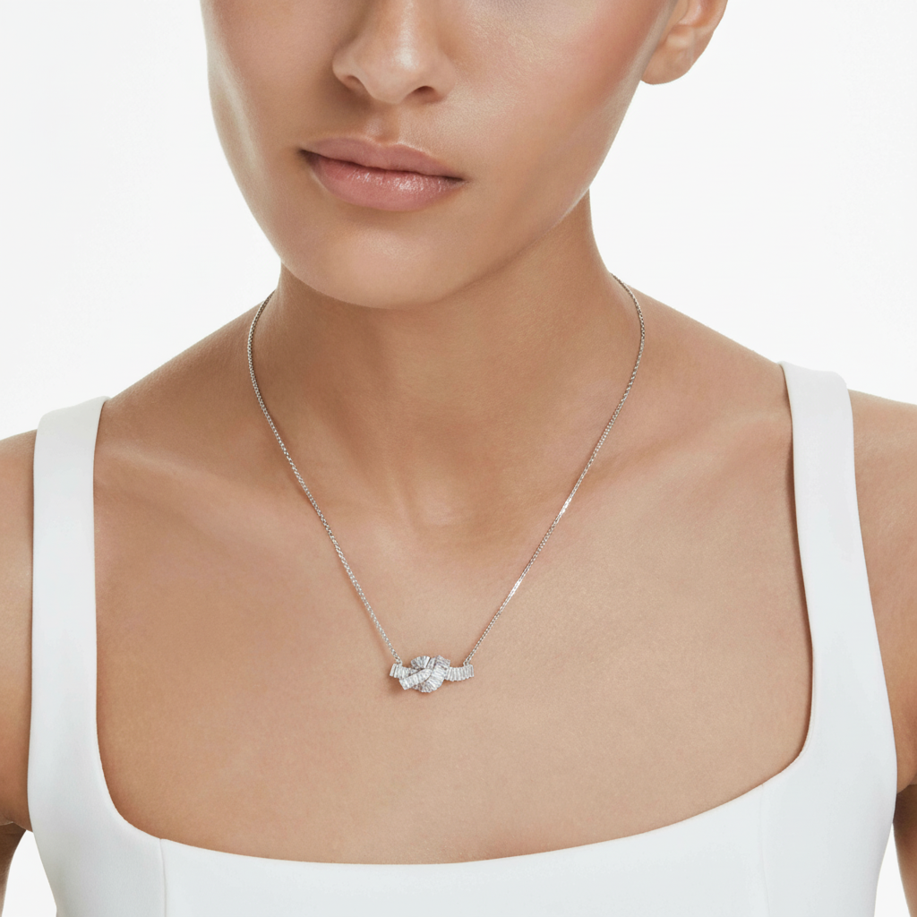 Swarovski Matrix pendant with baguette-cut white crystal, knot design, rhodium-plated silver jewelry piece.
