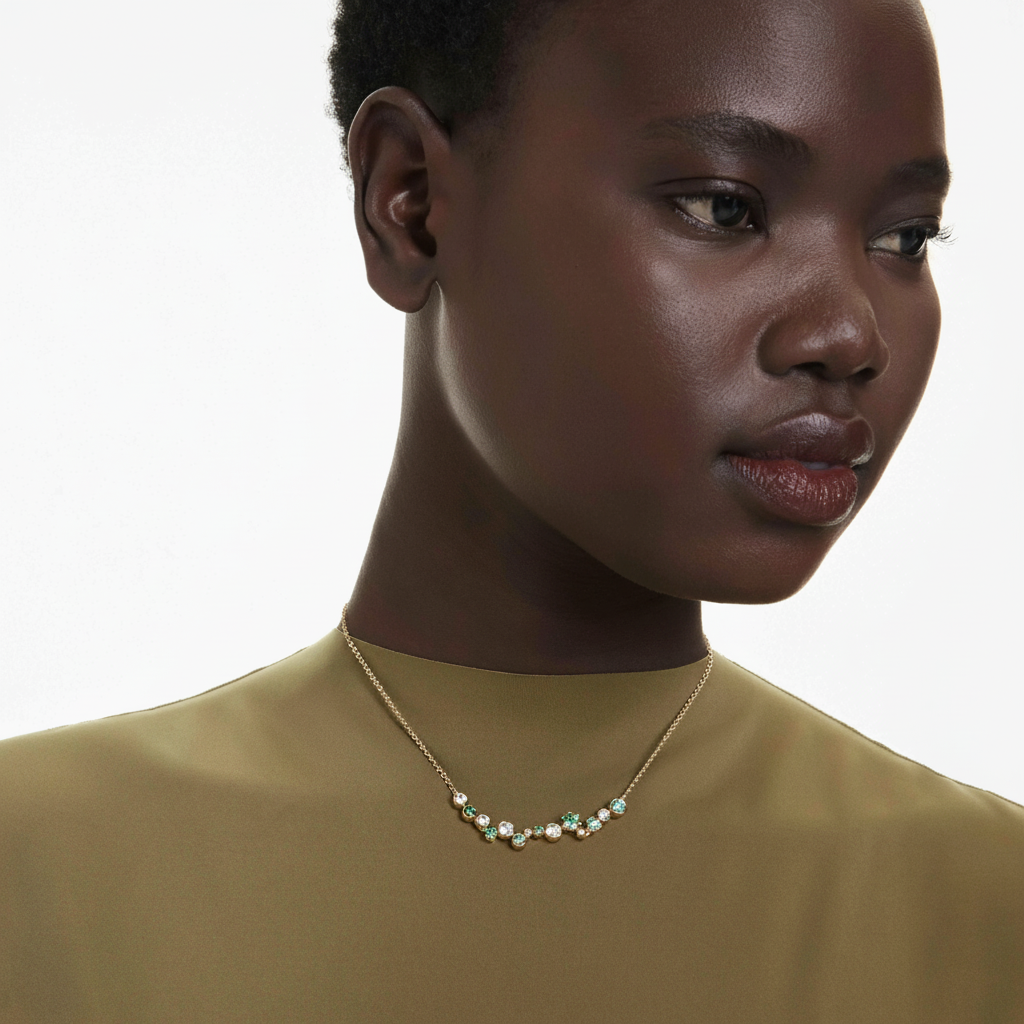 Swarovski Constella necklace with green mixed-cut crystals and gold-tone plated chain, elegant jewelry accessory.