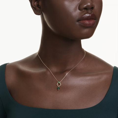 Swarovski Mesmera Pendant with green mixed cuts crystals and gold-tone plated setting, showcasing elegant jewelry design.