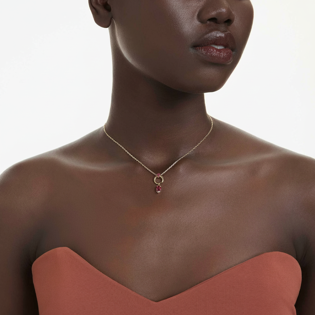Swarovski Mesmera pendant with mixed red cuts and gold-tone plating, showcasing sparkling crystal design and elegant jewelry style.