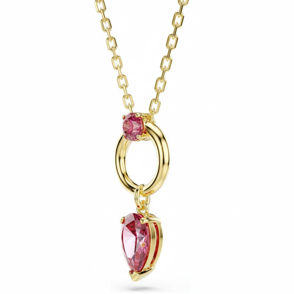 Swarovski Mesmera pendant with mixed-cut red crystals and gold-tone plating, elegant jewelry piece on a white background.