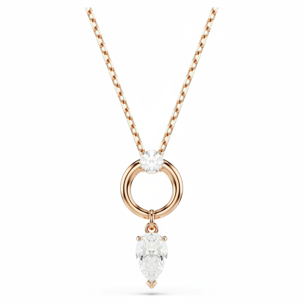 Swarovski Mesmera jewelry set featuring pear and round cut white crystals with rose gold-tone plating.