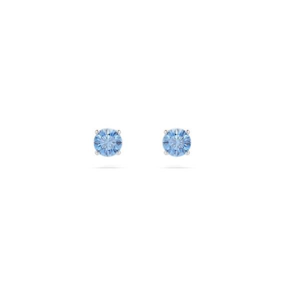 Swarovski Stilla Attract stud earrings with round blue gemstones and rhodium plating, showcasing elegant jewelry design.