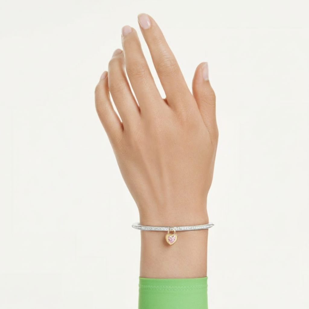 Swarovski Idyllia Bangle with mixed cuts, heart-shaped pink crystal, and mixed metal finish, elegant jewelry accessory.