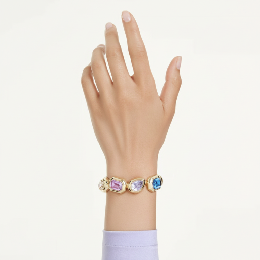 Swarovski Gema cuff with large multicolored crystals, mixed cuts, gold-tone plated jewelry showcasing oversized shimmering stones.