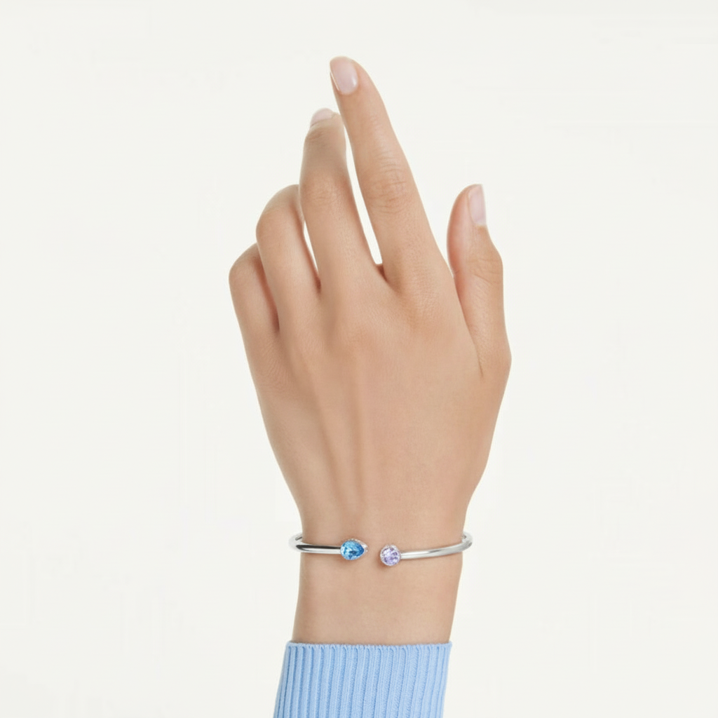 Swarovski Chroma Bangle featuring colorful crystal accents on a sleek silver-tone metal bracelet.