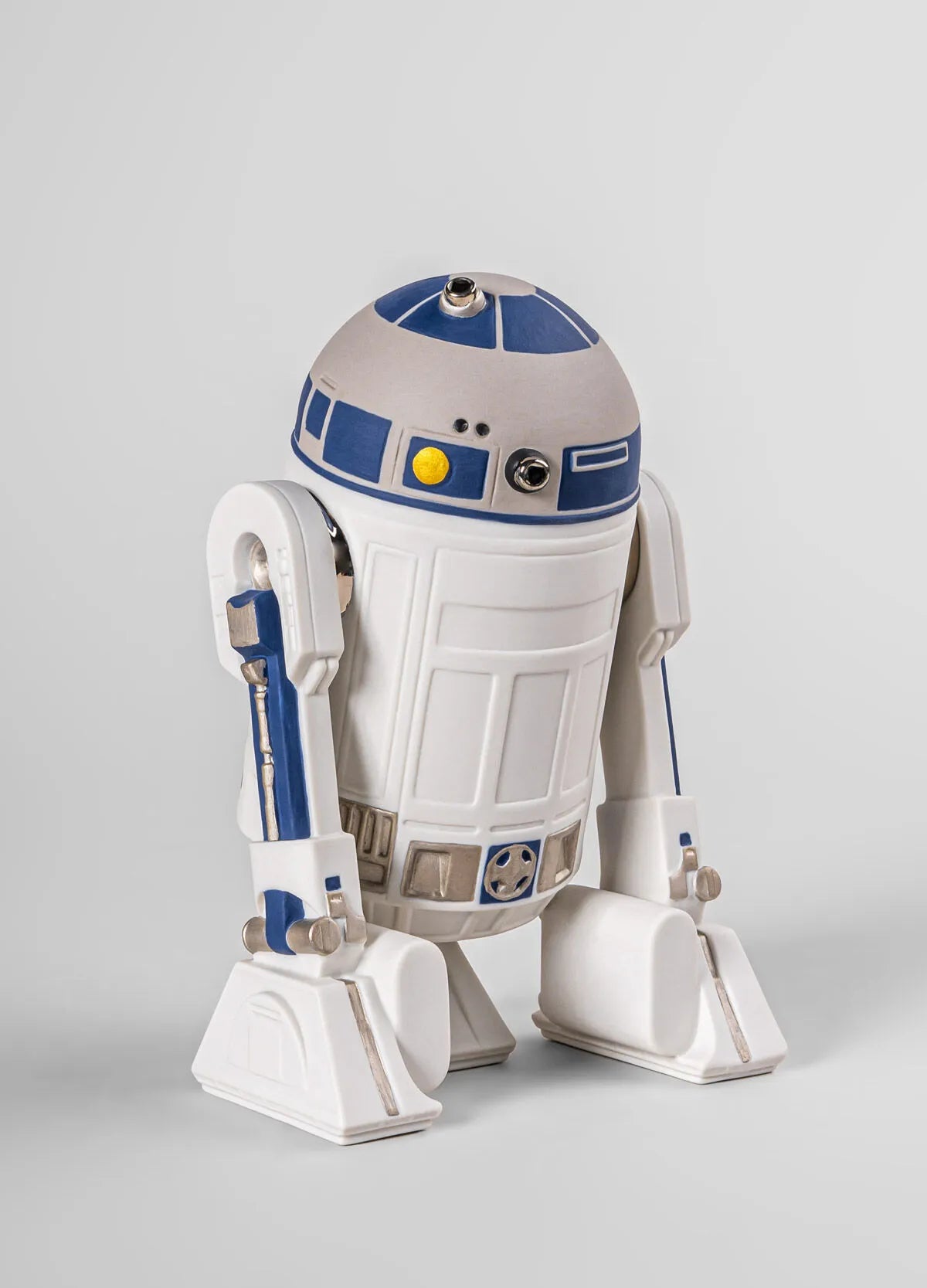 Lladro R2D2™ sculpture, detailed ceramic figurine of the iconic Star Wars droid with sleek white and blue design.