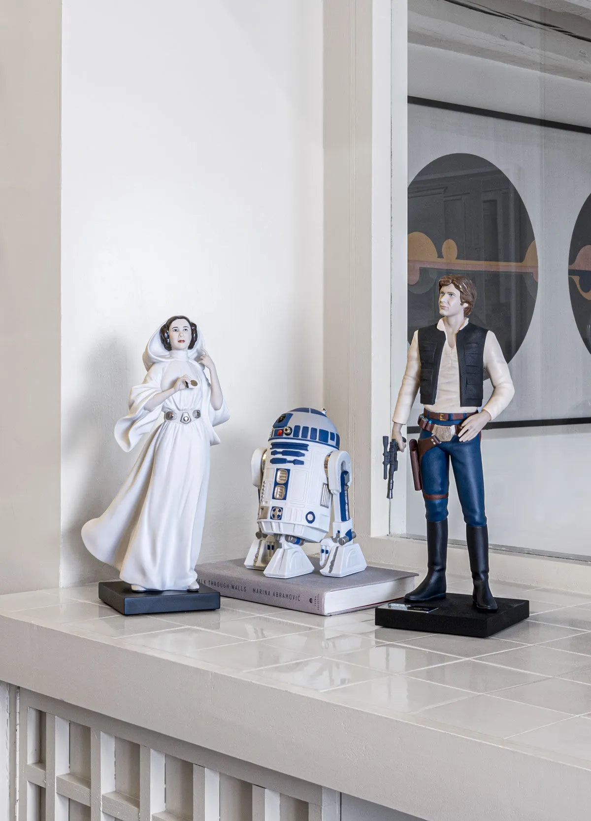 Lladro R2D2™ sculpture in white porcelain with detailed blue accents, showcasing a Star Wars-themed collectible figure.